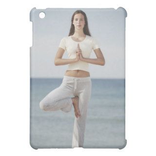 Woman doing yoga by the ocean iPad mini case