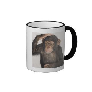 Monkey scratching its head mugs
