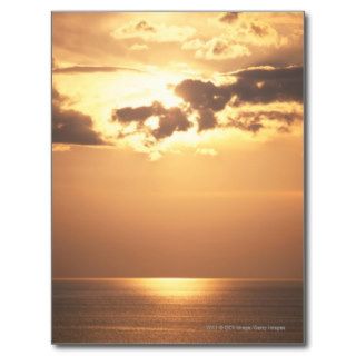 Sun goes down on the ocean post cards
