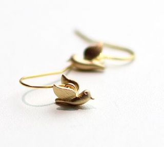 tiny gold bird in flight earrings by a box for my treasure