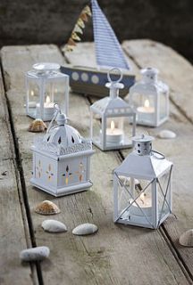 set of five assorted metal lanterns by the contemporary home