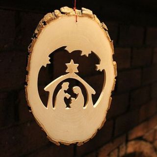 wooden hanging nativity with bark edge by nest