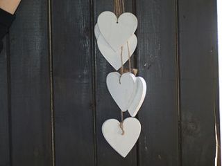 six white hanging hearts on rope by drift living