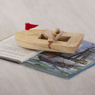 traditional wooden paddle boat toy by the contemporary home