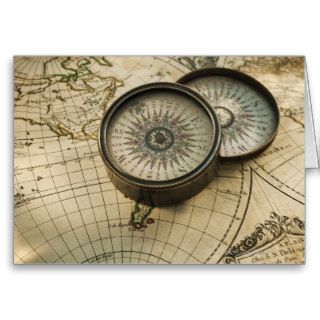 Antique compass on map card