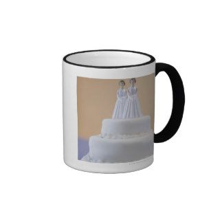 Wedding cake with two brides coffee mugs